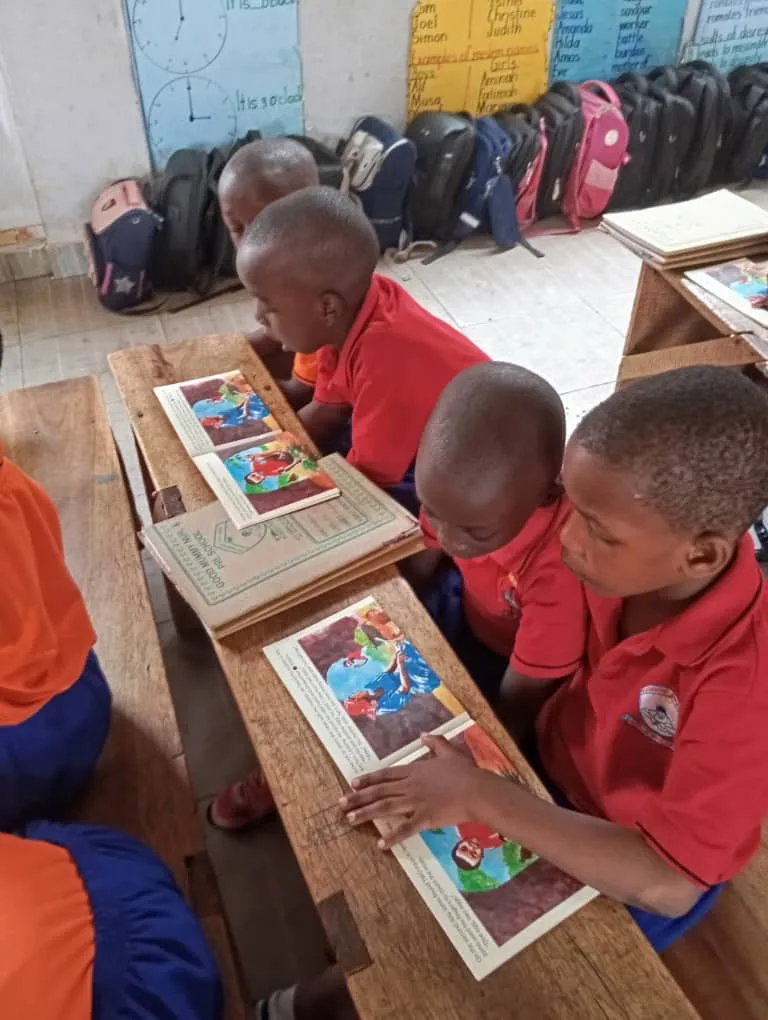 A class of learners reading Phonics Train books together