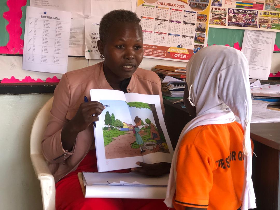 Phonics Train consultant conducting a reading exam with a learner