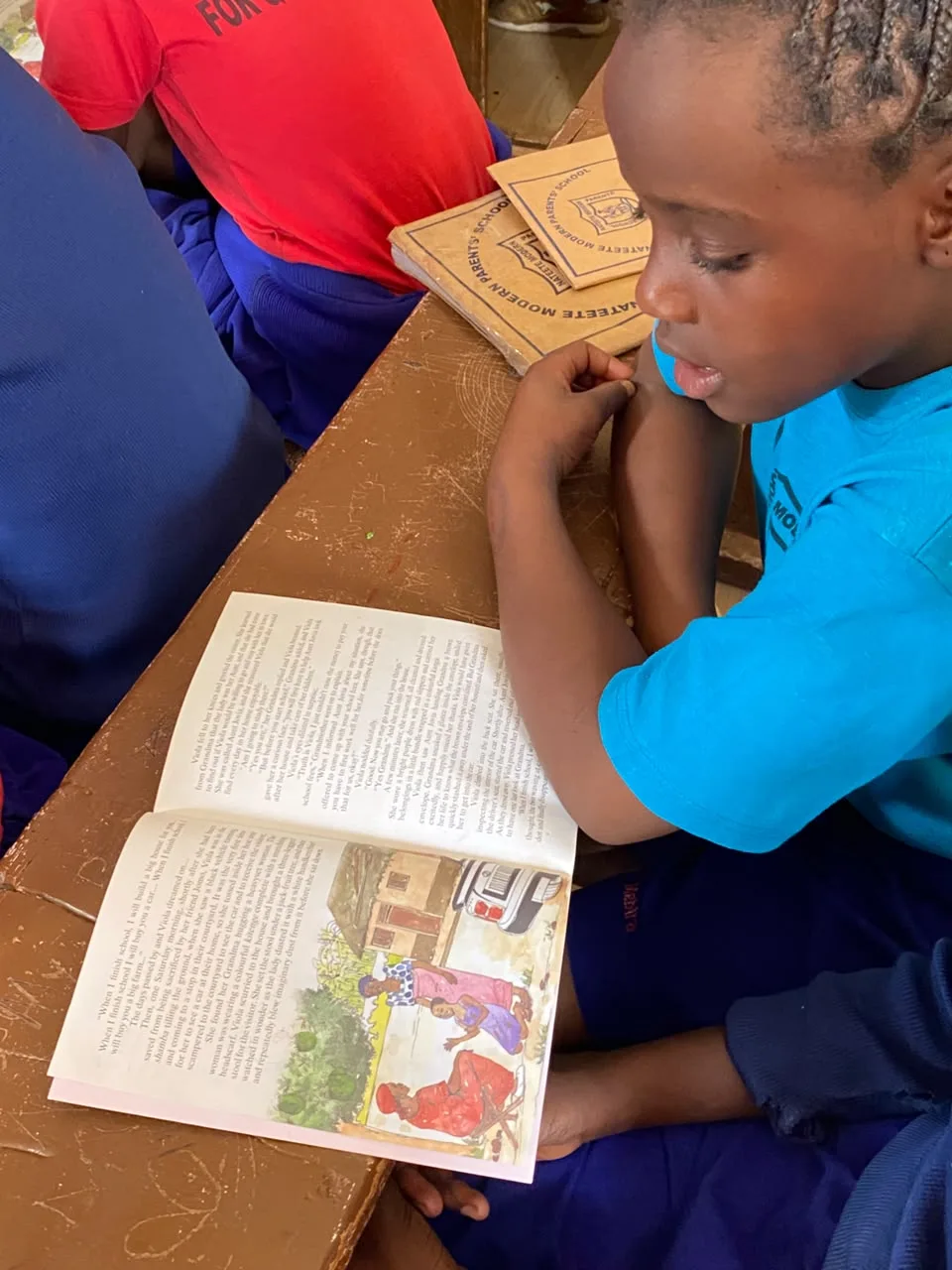 A learner reading a Phonics Train story book in class